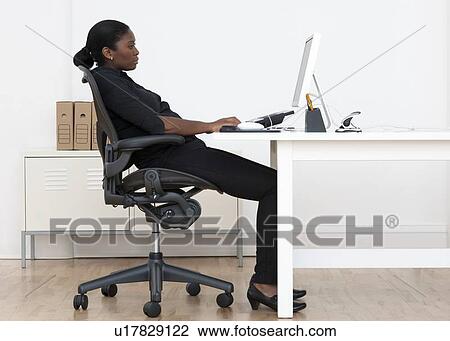 Stock Image - Incorrect seated posture. Fotosearch