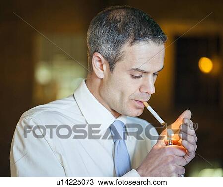 Man lighting a cigarette View Large Photo Image Stock Image - Man lighting a cigarette. Fotosearch