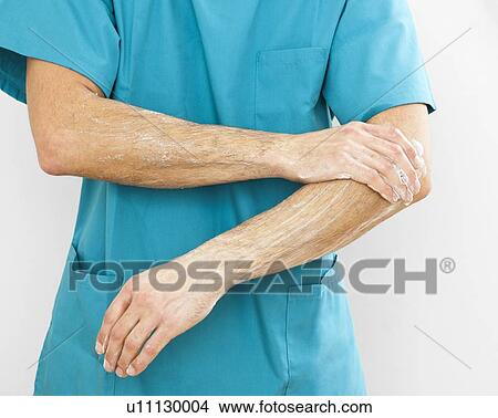 Picture - Scrubbing up before surgery. Fotosearch