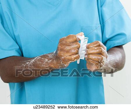 Stock Image - Scrubbing up before surgery. Fotosearch
