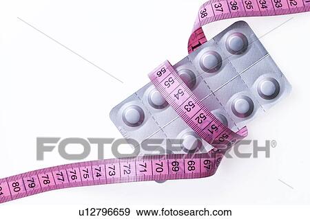 Slimming pills, conceptual image View Large Photo Image Stock Photo - Slimming pills, conceptual image. Fotosearch