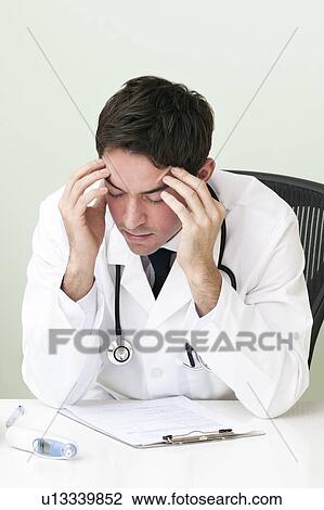Stressed doctor View Large Photo Image Stock Image - Stressed doctor. Fotosearch
