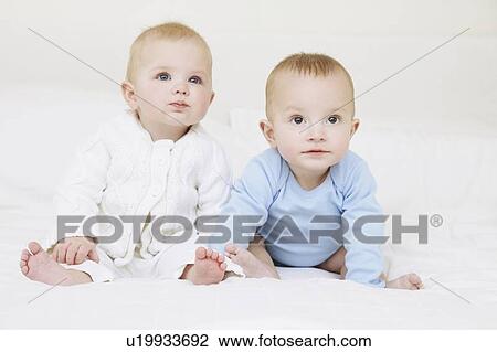 Babies sitting together on sofa View Large Photo Image Stock Image - Babies sitting together on sofa. Fotosearch