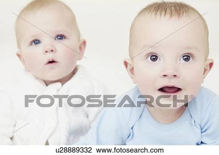 Babies sitting together on sofa View Large Photo Image Stock Image - Babies sitting together on sofa. Fotosearch