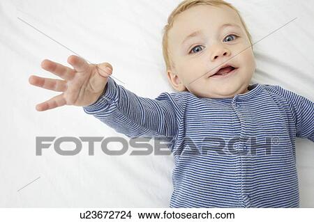 Baby girl laying on crib View Large Photo Image Picture - Baby girl laying on crib. Fotosearch