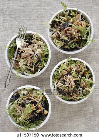 Stock Image - Bowls of endive and hazelnut salad. Fotosearch