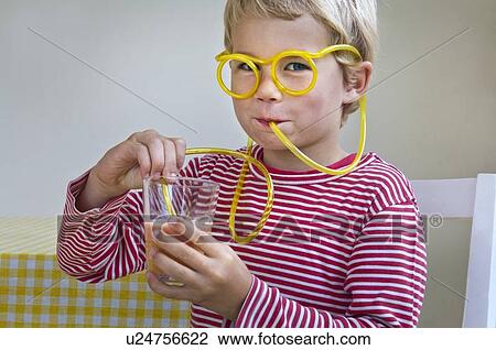 Boy drinking through curly straw View Large Photo Image Stock Image - Boy drinking through curly straw. Fotosearch