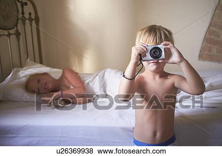 Boy taking picture in bedroom View Large Photo Image Stock Photo - Boy taking picture in bedroom. Fotosearch