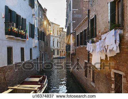 Buildings and rowboats on urban canal View Large Photo Image Stock Photo - Buildings and rowboats on urban canal. Fotosearch