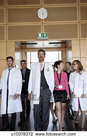 Stock Image - Business people and doctors in office. Fotosearch