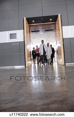 Stock Image - Business people and doctors in office. Fotosearch