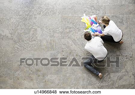 Stock Photo - Business people examining paint swatches. Fotosearch