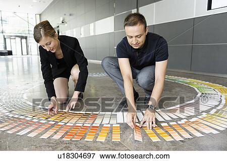 Business people examining paint swatches View Large Photo Image Stock Photo - Business people examining paint swatches. Fotosearch