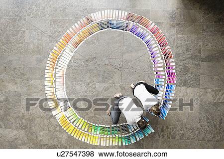 Business people examining paint swatches View Large Photo Image Stock Photo - Business people examining paint swatches. Fotosearch