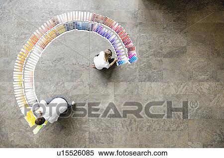 Stock Photography - Business people examining paint swatches. Fotosearch