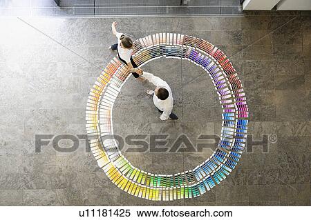 Stock Photography - Business people in paint swatches. Fotosearch