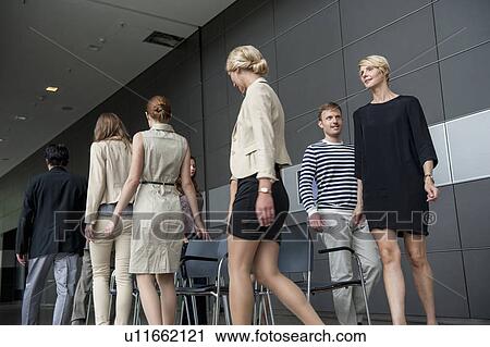 Stock Image - Business people playing musical chairs. Fotosearch