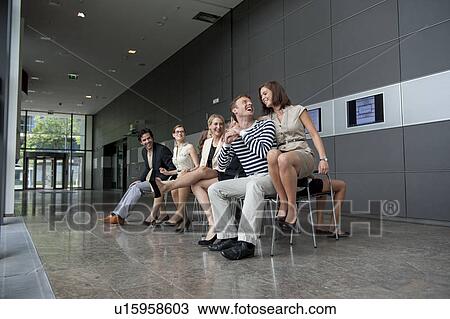 Stock Image - Business people playing musical chairs. Fotosearch