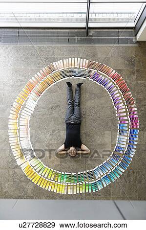 Stock Photo - Businessman laying with paint swatches. Fotosearch