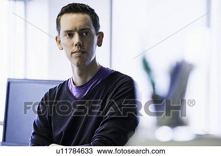 Businessman standing in office View Large Photo Image Stock Image - Businessman standing in office. Fotosearch