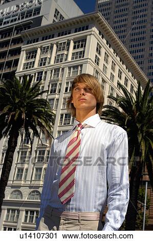 Businessman walking on city street View Large Photo Image Stock Image - Businessman walking on city street. Fotosearch