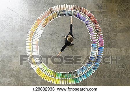 Stock Image - Businesswoman examining paint swatches. Fotosearch