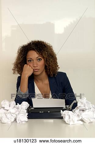 Stock Image - Businesswoman using typewriter. Fotosearch