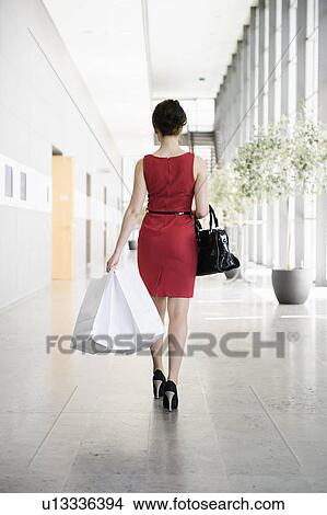 Businesswoman walking in lobby View Large Photo Image Picture - Businesswoman walking in lobby. Fotosearch