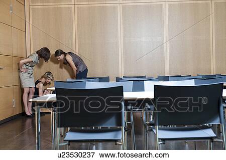 Businesswomen talking in office corner View Large Photo Image Stock Photo - Businesswomen talking in office corner. Fotosearch