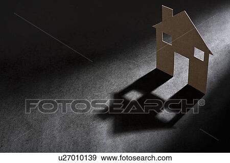 Cardboard house shape casting shadow View Large Photo Image Stock Photo - Cardboard house shape casting shadow. Fotosearch