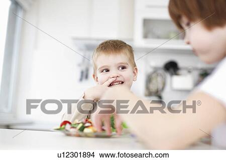 Picture - Children eating together at table. Fotosearch