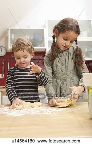 Children kneading dough in kitchen View Large Photo Image Stock Image - Children kneading dough in kitchen. Fotosearch
