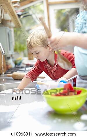 Children washing dishes together View Large Photo Image Stock Image - Children washing dishes together. Fotosearch