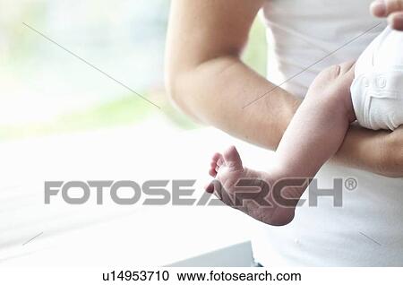 Stock Image - Close up of baby boys foot. Fotosearch