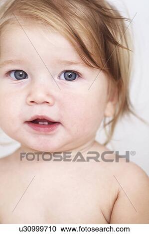 Stock Image - Close up of baby girls smiling face. Fotosearch