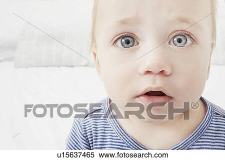 Stock Photography - Close up of baby girls surprised face. Fotosearch