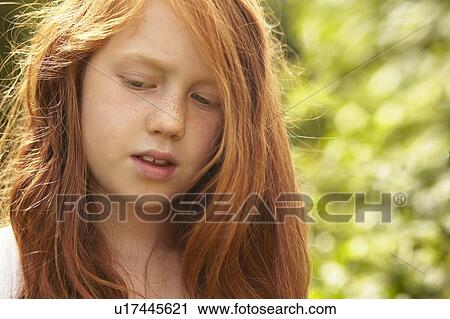Stock Image - Close up of girls serious face. Fotosearch