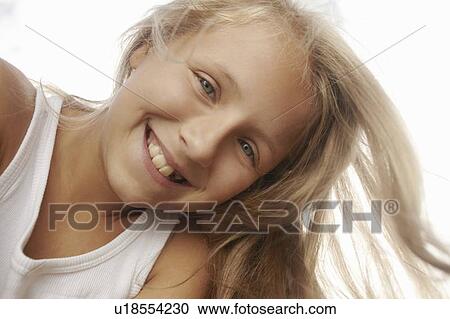 Stock Image - Close up of girls smiling face. Fotosearch