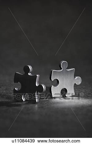 Close up of metal jigsaw pieces View Large Photo Image Stock Photo - Close up of metal jigsaw pieces. Fotosearch