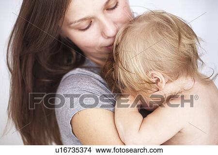 Picture - Close up of mother holding daughter. Fotosearch