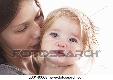 Stock Photo - Close up of mother holding daughter. Fotosearch