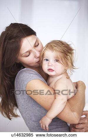Stock Photography - Close up of mother holding daughter. Fotosearch