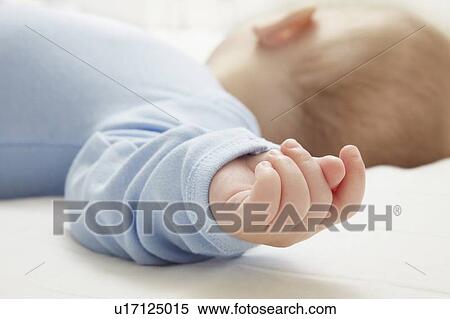 Stock Photography - Close up of sleeping babys hand. Fotosearch