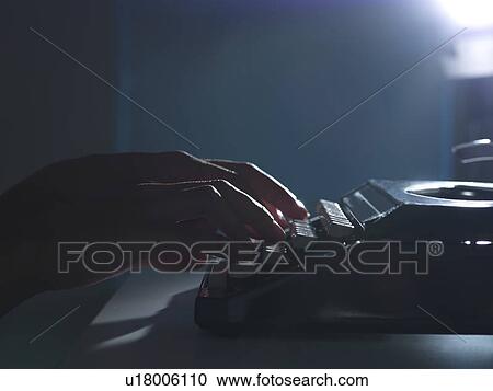 Stock Image - Close up of woman using typewriter. Fotosearch