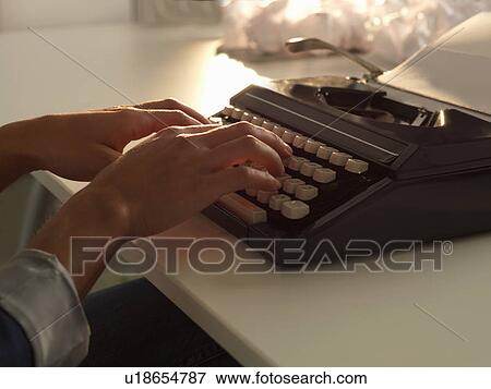 Stock Photo - Close up of woman using typewriter. Fotosearch