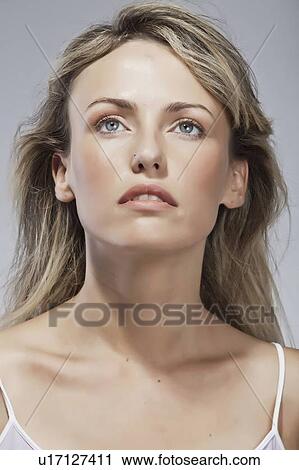 Stock Image - Close up of womans serious face. Fotosearch