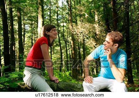 Couple sitting in forest View Large Photo Image Stock Photo - Couple sitting in forest. Fotosearch