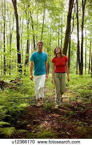 Couple walking in forest View Large Photo Image Stock Image - Couple walking in forest. Fotosearch