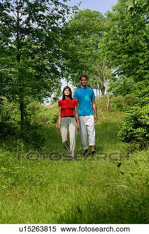 Couple walking in meadow View Large Photo Image Stock Photography - Couple walking in meadow. Fotosearch