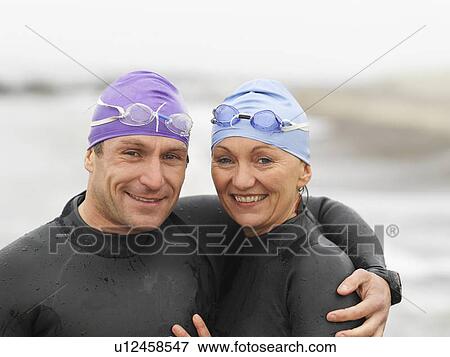 Divers smiling together on beach View Large Photo Image Stock Photo - Divers smiling together on beach. Fotosearch